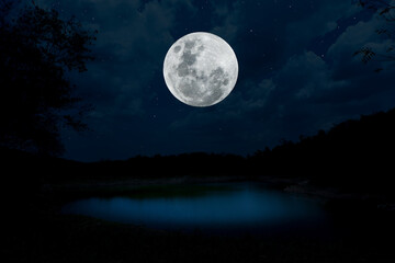 Fototapeta na wymiar Full moon over lake at night.