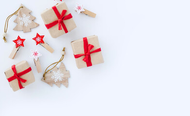 Flat lay minimal composition with Christmas gift boxes and New Year decorations on white background with copy space.