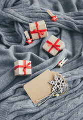Merry Christmas blank card with snowflake, gift boxes and decorations on gray background.