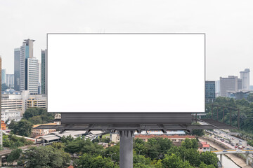 Blank white road billboard with KL cityscape background at day time. Street advertising poster, mock up, 3D rendering. Front view. The concept of marketing communication to promote or sell idea.