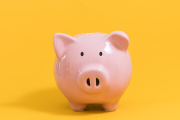 Piggy bank on yellow background for economy, saving money wealth and financial concept