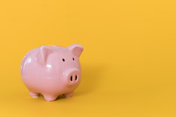 Piggy bank on yellow background for economy, saving money wealth and financial concept