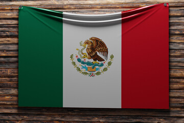 3D illustration of the national   fabric flag of Mexico nailed on a wooden wall .Country symbol.