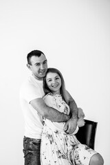 young man in love hugging his wife and smiling sincerely. black and white photo