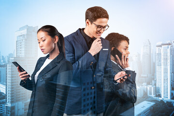 Group of successful smiling businesspeople in suits using smart phone and thinking how to tackle...