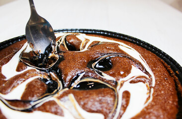 Chocolate cake for your design. Delicious caramel chocolate cake with nuts. Homemade chocolate cake, with powdered sugar close-up.