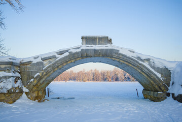 Arch of the old Humpbacked Bridge close up on a frosty January evening. Gatchina, Russia
