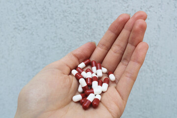Hand holding pills - Medicine, prescription drugs