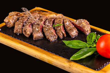 FOOD - Grilled Beef Steak on the iron plate with salt crystals, basil and tomato