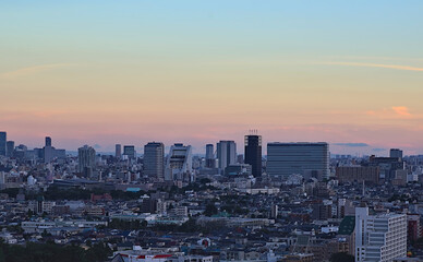 Fototapeta na wymiar Aerial view of the Nakano skyline in the early evening under a partly cloudy sky