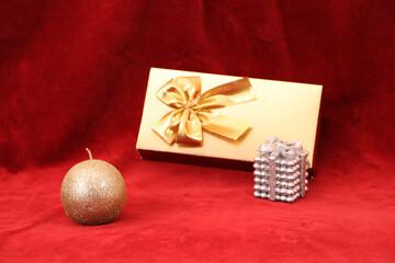 Christmas and New Year gifts as a symbol of New Year and Christmas.  Christmas festive decor with tree, candle, gifts on a red background.