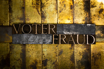 Voter Fraud text message on textured grunge copper and vintage gold background