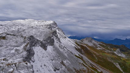 Beautiful panoramic view of the snow-capped rugged Rätikon mountains near Gargellen in Montafon, Alps at the border of Austria and Switzerland on a cloudy day in autumn season.