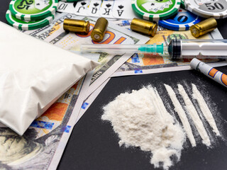 syringe hundred dollars bills cocaine heroine playing chips and cards and pistol cartridges drug...