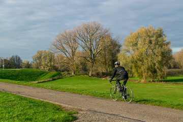 Dutch people cycle on dike
