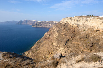 The coast of Santorini Island in Greece, impressive volcanic cliffs and a view of the caldera. Viewpoint to the Plaka bay. Cyclades Islands