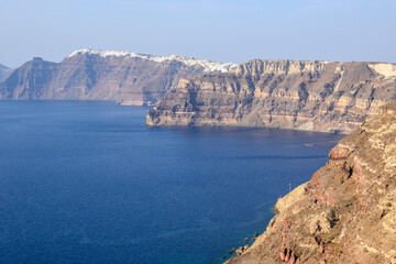 Obraz premium The coast of Santorini Island in Greece, impressive volcanic cliffs and a view of the caldera in Megalochori village. Cyclades Island