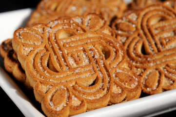 Freshly baked cookies sprinkled with sugar closeup. Shallow depth of field