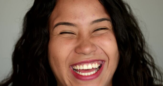 Casual hispanic girl laughing and smiling. Latina young woman real life laugh and smile