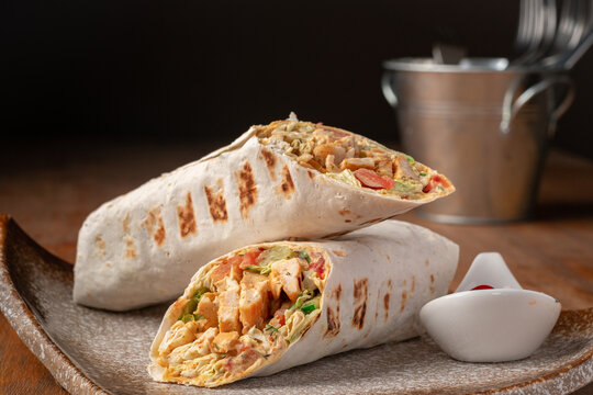 Chicken Doner-kebab or roll with chicken and mustard sauce on a plate