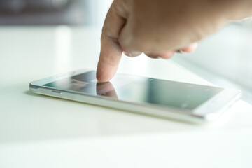 Digital Smartphone disruption concept, Hand using mobile for searching information data internet on table in home over blur background. Technology / internet of things for new generation