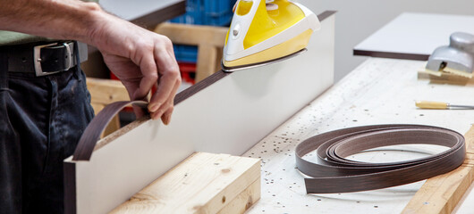 Iron on the wood veneer edge. cabinet wood with Iron-on Edge Banding. Applying Wood Veneer Edging...