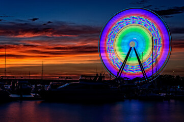 Illuminated Capital Wheel ferris ride at National Harbor near Washington DC at sunset