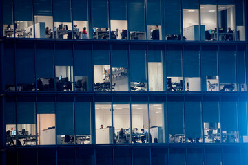 office building facade - business people working at night