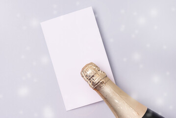 Bottle of Champagne Wine and White Foarm on Blue Background Drawing Snow Top View Horizontal New Year Holiday Mock Up