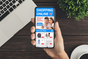 Woman Holding Cellphone Shopping Online Buying Clothes Indoor, Closeup