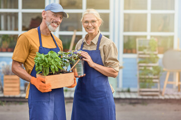 Middle aged caucasian partners on garden house background