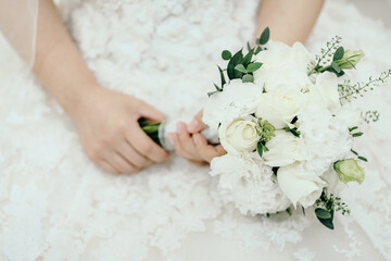 
The bride is holding a bouquet before the wedding