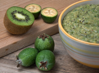 Ceramic bowl with mashed feijoa with kiwi and sugar.