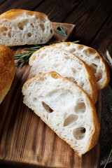 Italian ciabatta bread on wooden table.