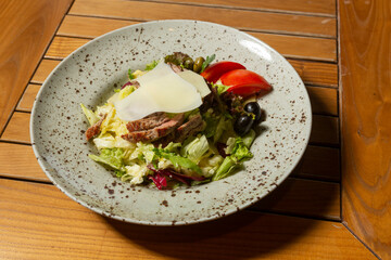 Mixed green salad with beef steak