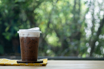Iced mocha in plastic cup. Coffee beverage in coffee house
