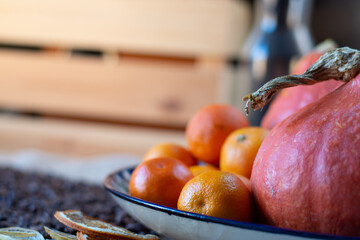 Juicy pumpkin with tangerines on a plate
