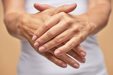 Lady is using a cosmetic hand moisturizer