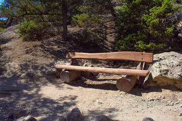 a bench made of wood in the mountains