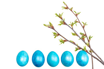 Three young spring twigs of a branch with green leaves with Easter blue eggs