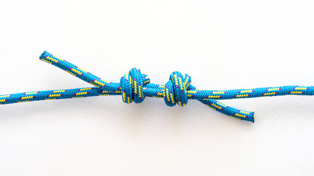 Double fisherman's bend knot pulled loose on a white background