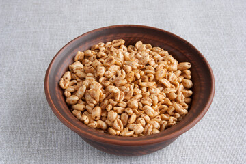 delicious airy wheat in honey glaze in a clay bowl