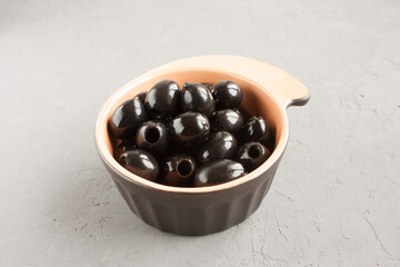 seedless black olives in a bowl on the table