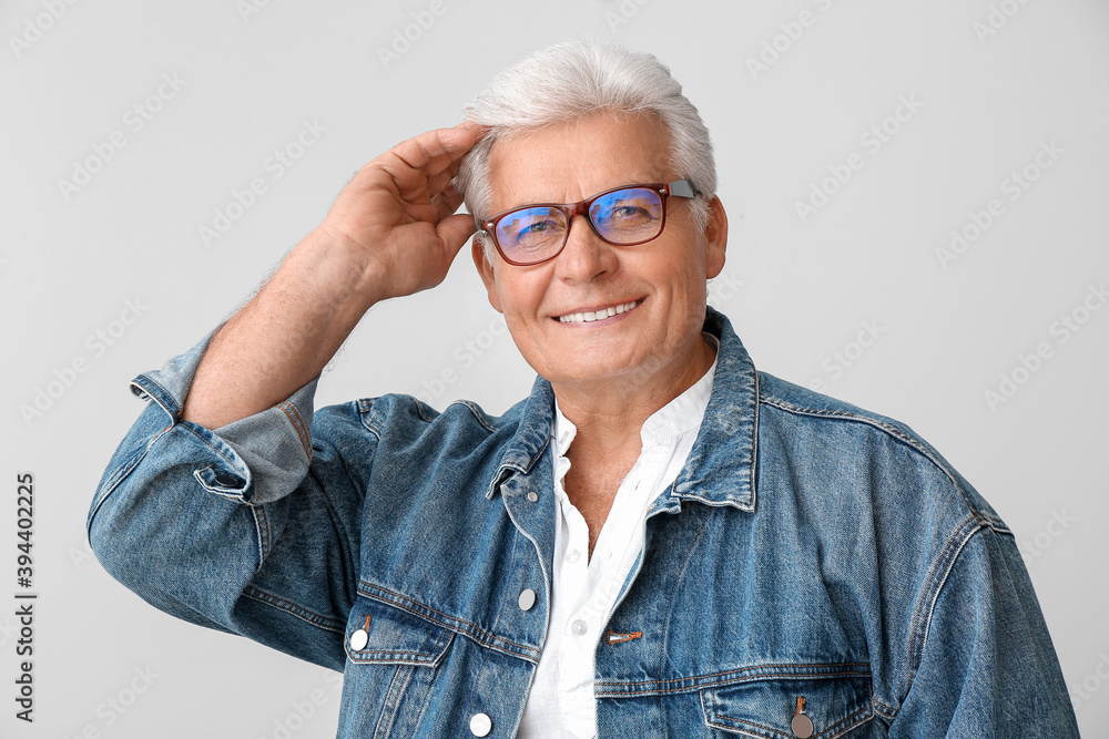 Poster Stylish senior man on grey background