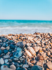 pebbles on the shore against the backdrop of a blue beautiful ocean