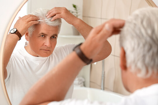 Senior Man With Grey Hair Near Mirror