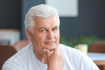 Portrait of senior man resting at home