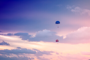 Parasailing on sunset and blue sky background in tropical country