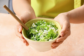 Woman holding rice salad, closeup