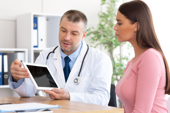 Adult doctor showing patient tablet with black blank screen